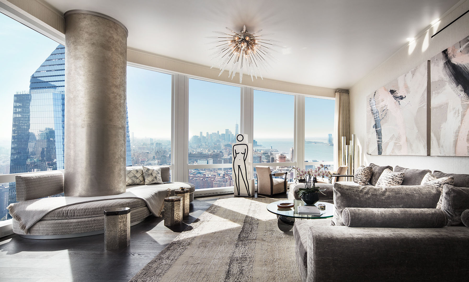 Living room with expansive Hudson River and city views